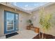 Inviting entryway with a teal door, decorative wall art, and potted plants at 10079 83Rd Way, Seminole, FL 33777