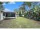 Spacious backyard with lush landscaping and screened enclosure at 10504 Tapestry Dr, Port Richey, FL 34668