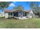 Screened patio and fenced backyard with mature trees at 10504 Tapestry Dr, Port Richey, FL 34668