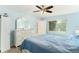 Bedroom with white dresser and blue bedding at 10504 Tapestry Dr, Port Richey, FL 34668
