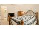 Bedroom with wooden dresser and patterned bedding at 10504 Tapestry Dr, Port Richey, FL 34668