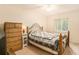 Bedroom with wooden dresser and patterned bedding at 10504 Tapestry Dr, Port Richey, FL 34668