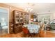 Charming dining room with a round table and wooden hutch at 10504 Tapestry Dr, Port Richey, FL 34668
