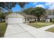 Ranch style home with a two car garage and well-kept landscaping at 10504 Tapestry Dr, Port Richey, FL 34668