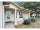 Inviting front porch with a white door and large window at 10504 Tapestry Dr, Port Richey, FL 34668