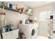 Laundry room with washer, dryer, and shelving for storage at 10504 Tapestry Dr, Port Richey, FL 34668