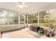 Bright sunroom with backyard view, tile flooring, and ample natural light at 10504 Tapestry Dr, Port Richey, FL 34668
