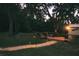 Landscaped backyard with a path and outdoor seating at 11421 Petrel Ave, Weeki Wachee, FL 34614