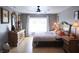 Spacious bedroom with large windows, ceiling fan, and ample dresser space at 11421 Petrel Ave, Weeki Wachee, FL 34614