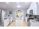 Modern kitchen with white cabinets, granite countertops, and access to backyard at 11421 Petrel Ave, Weeki Wachee, FL 34614