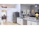 Modern kitchen with white cabinets, granite countertops and stainless steel appliances at 11421 Petrel Ave, Weeki Wachee, FL 34614