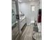 Modern bathroom with white vanity, marble tile, and walk-in shower at 1202 W Camellia Dr, Brandon, FL 33510