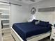 Bright bedroom with a white bed frame and navy bedding at 1202 W Camellia Dr, Brandon, FL 33510