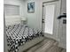 Guest bedroom with a black and white comforter and a door to outside at 1202 W Camellia Dr, Brandon, FL 33510