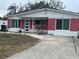 Brick house with white accents, rocking chairs on porch at 1202 W Camellia Dr, Brandon, FL 33510