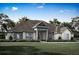 Single-story home with stone accents and a large front yard at 17342 Nokota Ave, Hudson, FL 34667