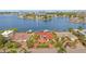 Aerial view of waterfront home with red tile roof, boat dock, and circular driveway at 1818 Dolphin S Blvd, St Petersburg, FL 33707