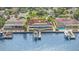 Aerial view of waterfront home, featuring solar panels and private dock at 1818 Dolphin S Blvd, St Petersburg, FL 33707