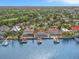 Waterfront home with private dock and boats, surrounded by lush landscaping at 1818 Dolphin S Blvd, St Petersburg, FL 33707
