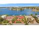 Bird's-eye view of house on waterfront with red roof, dock, and spacious driveway at 1818 Dolphin S Blvd, St Petersburg, FL 33707