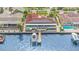 An aerial view showcasing a waterfront home with solar panels and a private dock at 1818 Dolphin S Blvd, St Petersburg, FL 33707