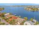 An aerial view of a waterfront home with a red tile roof and private dock at 1818 Dolphin S Blvd, St Petersburg, FL 33707