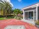 Front entry with red brick driveway and tropical landscaping at 1818 Dolphin S Blvd, St Petersburg, FL 33707