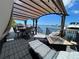 Relaxing waterfront patio with pergola, seating, and fire pit at 1818 Dolphin S Blvd, St Petersburg, FL 33707