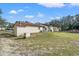 Spacious backyard with large grassy area, shed, and above ground pool at 18801 Orange Hill Dr, Hudson, FL 34667