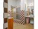 Bathroom with checkered tile and a shower/tub combo at 18801 Orange Hill Dr, Hudson, FL 34667
