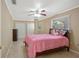 Bedroom with a pink comforter and double closets at 18801 Orange Hill Dr, Hudson, FL 34667