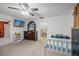 Well-lit bedroom, featuring a twin bed and large TV at 18801 Orange Hill Dr, Hudson, FL 34667