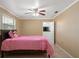 Bedroom with a pink comforter and ceiling fan at 18801 Orange Hill Dr, Hudson, FL 34667