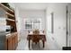 Bright dining area with wood table and built-in shelving at 18801 Orange Hill Dr, Hudson, FL 34667