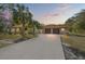 House exterior featuring a two-car garage and a spacious driveway at 18801 Orange Hill Dr, Hudson, FL 34667