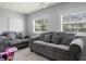 Sunken living area with gray couches and star ceiling at 18801 Orange Hill Dr, Hudson, FL 34667