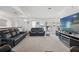 Living room featuring comfortable leather sofas and a large TV at 18801 Orange Hill Dr, Hudson, FL 34667