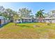Spacious backyard with a large grassy area and mature trees at 21 Belle Meade Cir, Largo, FL 33770