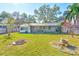 Large backyard with a stone fire pit and a tranquil atmosphere at 21 Belle Meade Cir, Largo, FL 33770