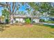 Charming single-story home with a spacious front yard and mature trees at 21 Belle Meade Cir, Largo, FL 33770