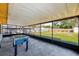Screened in patio with foosball table and backyard view at 21 Belle Meade Cir, Largo, FL 33770