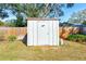 White storage shed in the backyard, offering extra storage space at 21 Belle Meade Cir, Largo, FL 33770