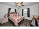 Cozy bedroom with a full-size bed and ceiling fan at 2820 Highlands Blvd # A, Palm Harbor, FL 34684