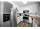 Modern kitchen with stainless steel appliances and granite countertops at 2820 Highlands Blvd # A, Palm Harbor, FL 34684