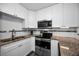 Updated kitchen, featuring stainless steel appliances and granite countertops at 2820 Highlands Blvd # A, Palm Harbor, FL 34684