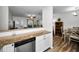 Modern kitchen with white cabinets, granite counters, and stainless steel appliances at 2820 Highlands Blvd # A, Palm Harbor, FL 34684