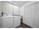 Bright laundry room with washer, dryer, and built-in storage at 2820 Highlands Blvd # A, Palm Harbor, FL 34684