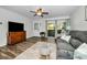Bright living room with comfy seating, wood-look floors, and sliding glass doors at 2820 Highlands Blvd # A, Palm Harbor, FL 34684
