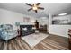 Open living room showcasing a gray couch and access to the kitchen and dining area at 2820 Highlands Blvd # A, Palm Harbor, FL 34684