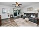Living room features wood-look floors, comfy seating and access to a patio at 2820 Highlands Blvd # A, Palm Harbor, FL 34684